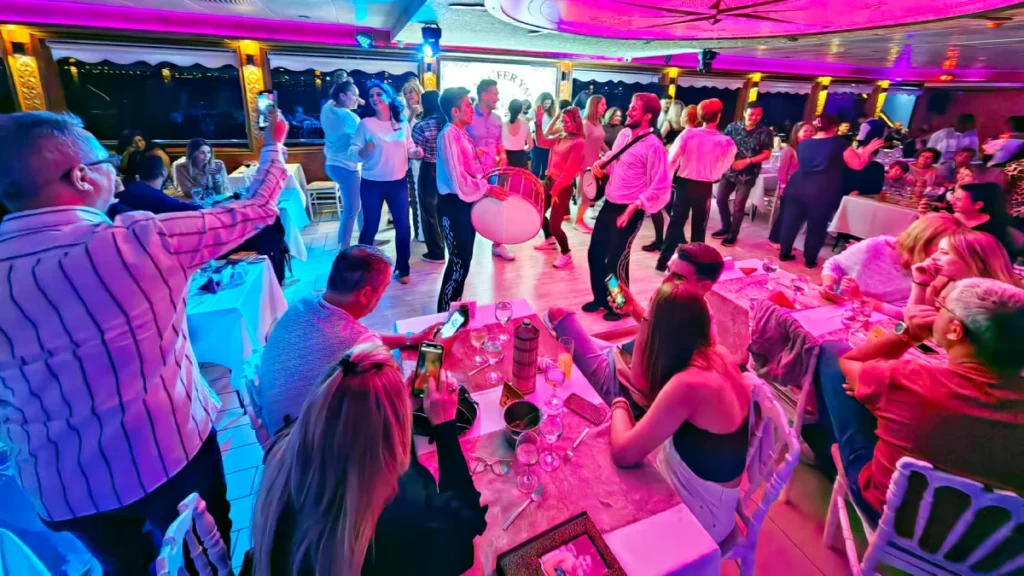 Nighttime Bosphorus boat party with colorful lights in Istanbul