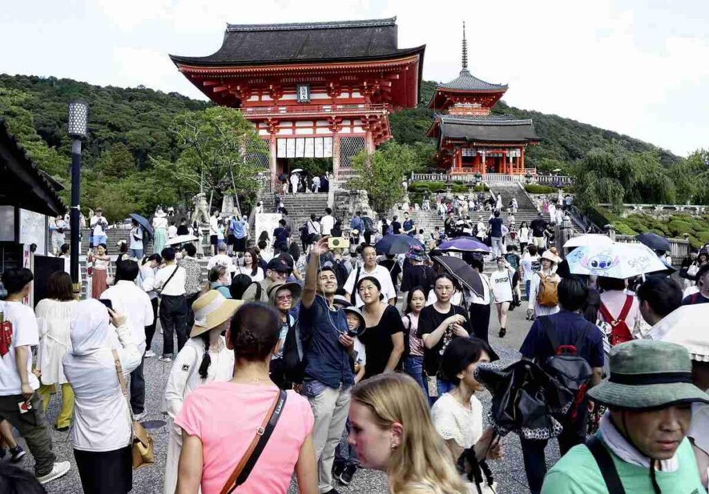 Crowds of tourists at Kiyomizudera temple in Kyoto during peak season