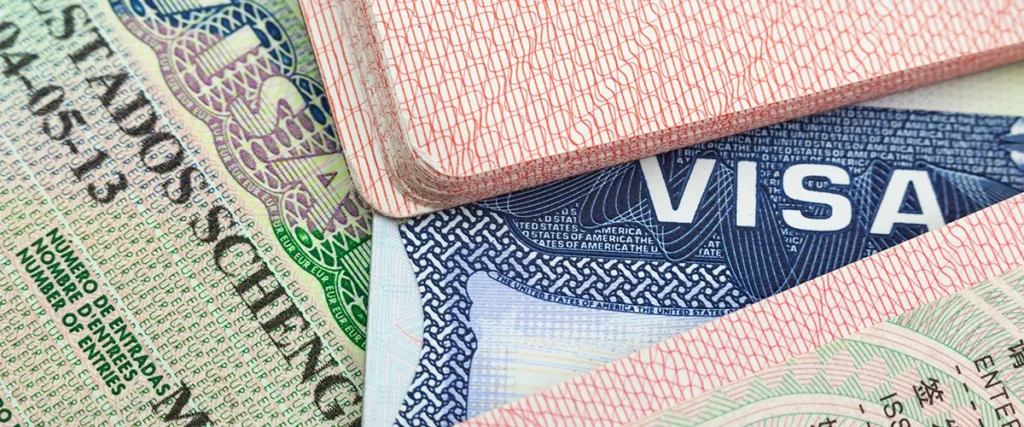 Passport and visa documents for planning entry requirements on a multi-country trip