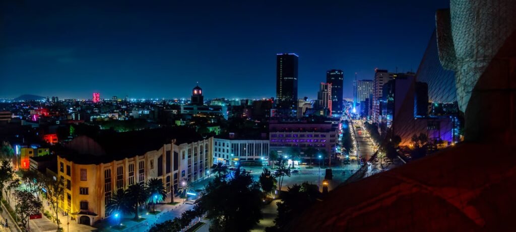 Aerial view of Condesa and Roma neighborhoods lit up at night, Mexico City