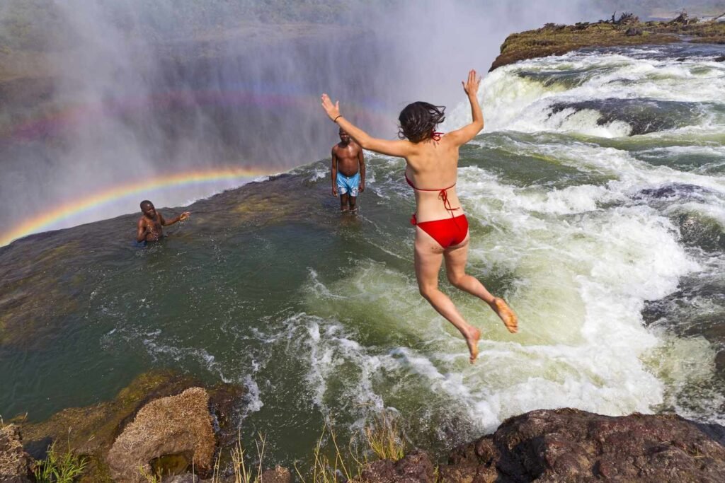 Travelers swimming at Devil's Pool above Victoria Falls