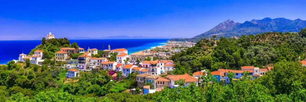 Coastal village and pine-forested mountains on Samos island Greece in the Aegean Sea