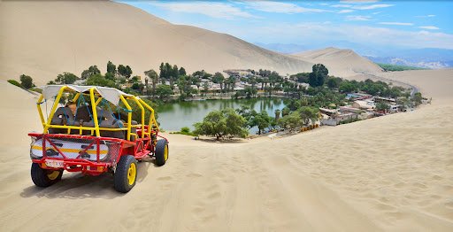 Dune buggy speeding across the Huacachina desert