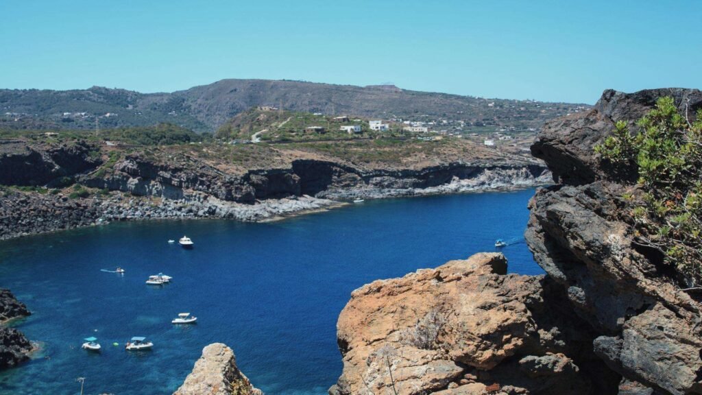 Volcanic coastline and dammusi houses on Pantelleria island Italy