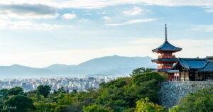 Kyoto cityscape with red pagoda and forested hills – a view beyond the temples
