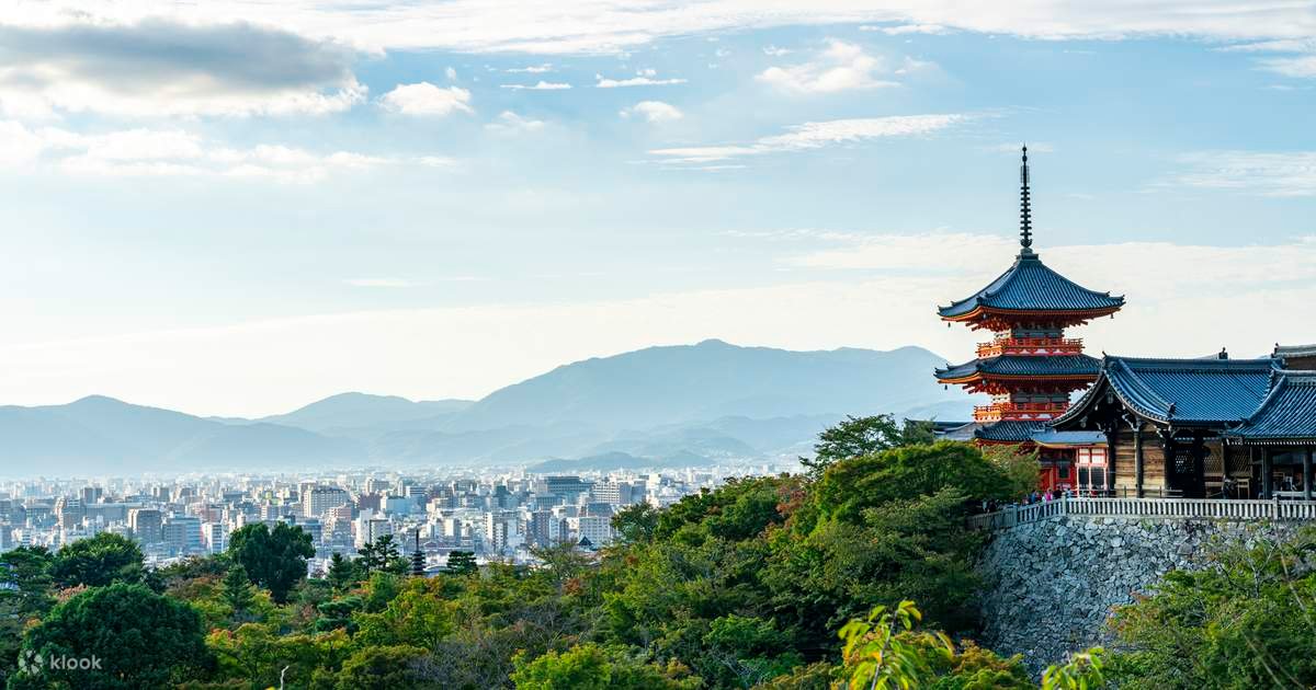 Kyoto cityscape with red pagoda and forested hills – a view beyond the temples
