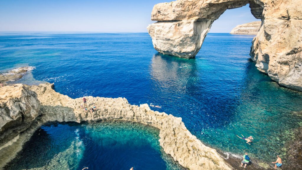Limestone sea arch and crystal clear water at Dwejra on Gozo island Malta