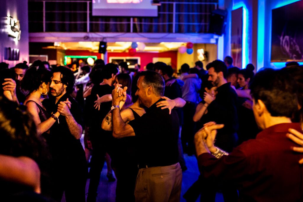 Couples dancing tango at a milonga dance hall in Buenos Aires