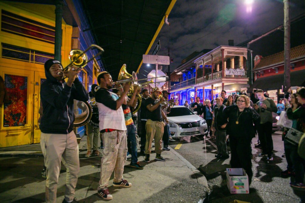 Brass band musician playing on Frenchmen Street at night in New Orleans