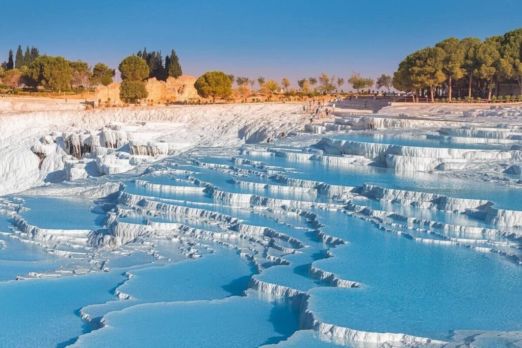 Pamukkale white travertine terraces with blue thermal pools, Turkey