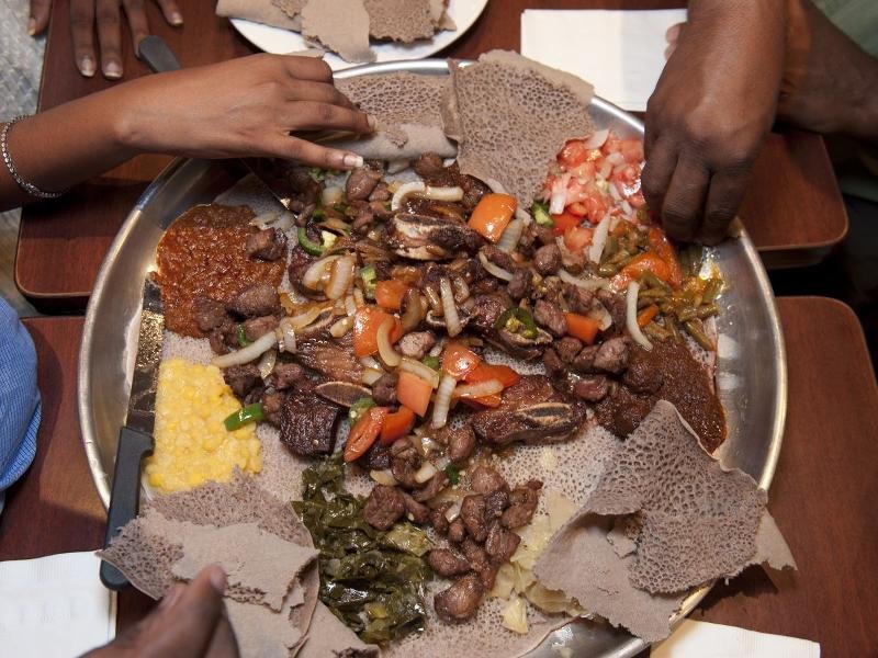 Ethiopian injera platter with tibs, misir wat and gomen – traditional food in Lalibela Ethiopia travel guide