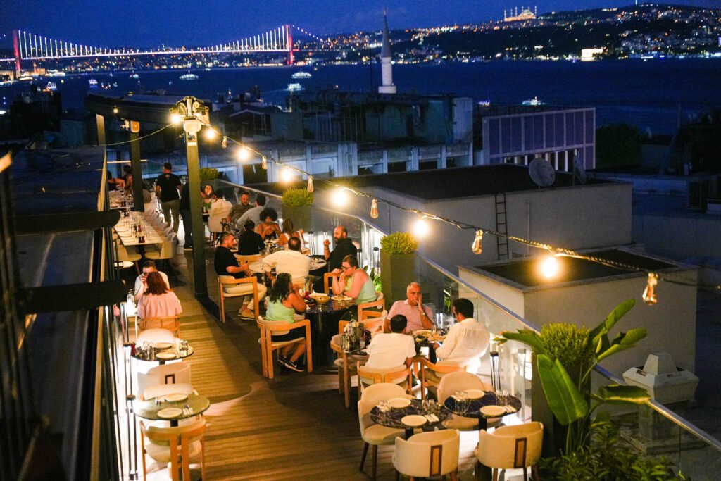 Rooftop meyhane dinner with Bosphorus view in Istanbul at dusk