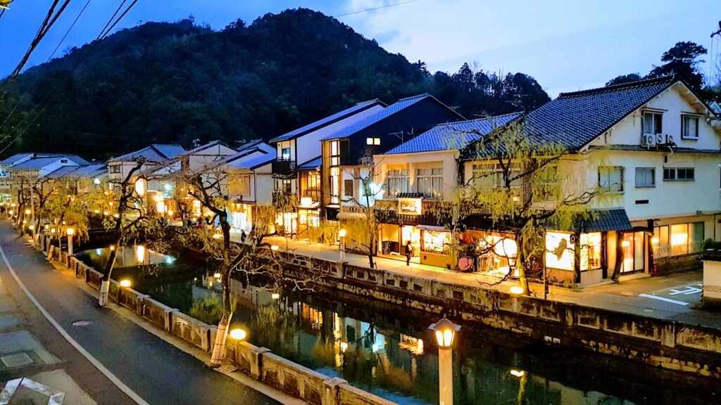 Kinosaki Onsen town canal with traditional Japanese lanterns at dusk - Japan travel guide